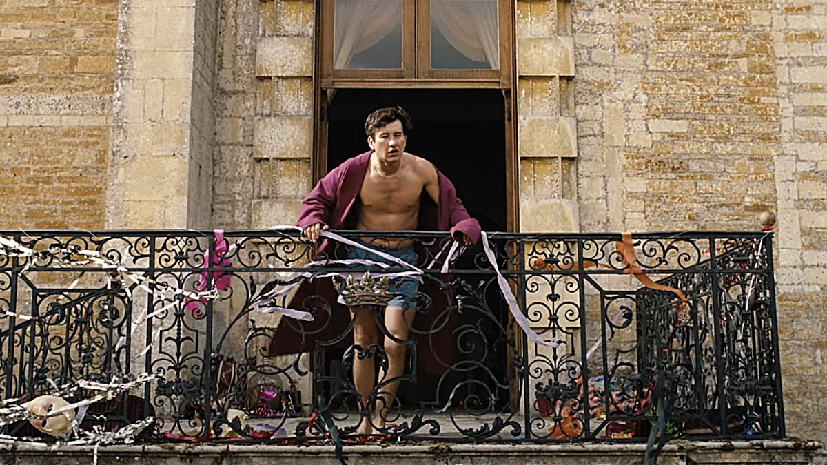 Barry Keoghan looking out a balcony after a wild night in Emerald Fennell's 'Saltburn'.