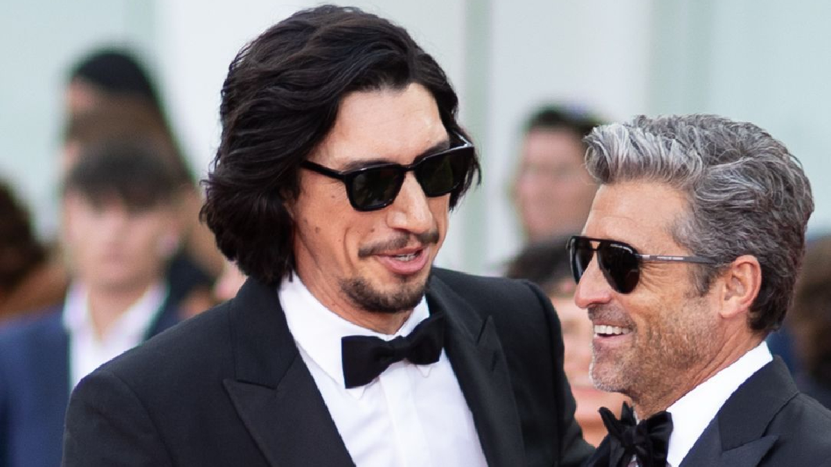 Adam Driver and Patrick Dempsey are standing together on a red carpet.