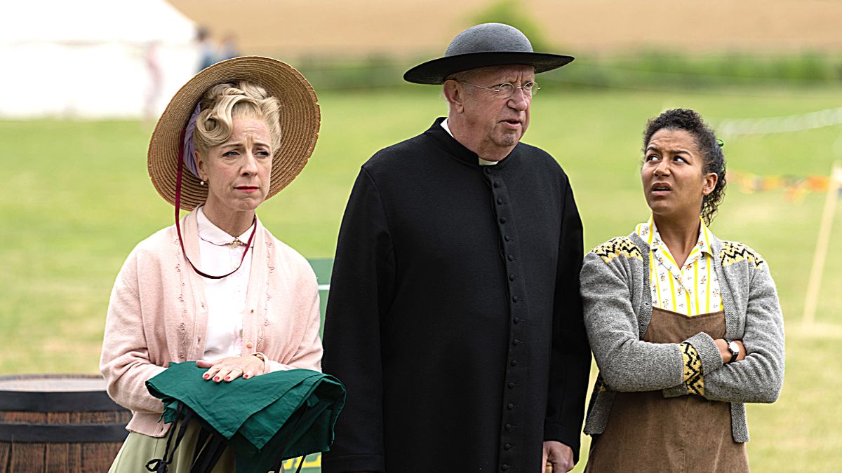 Claudie Blakley as Mrs. Devine, Mark Williams as Father Brown, and Ruby-May Martinwood as Brenda Palmer in 'Father Brown' Season 11