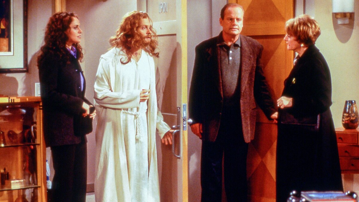 Frasier, Fay, and Mrs. Moskowitz stand in Frasier's doorway as Niles dressed as Jesus enters the apartment 