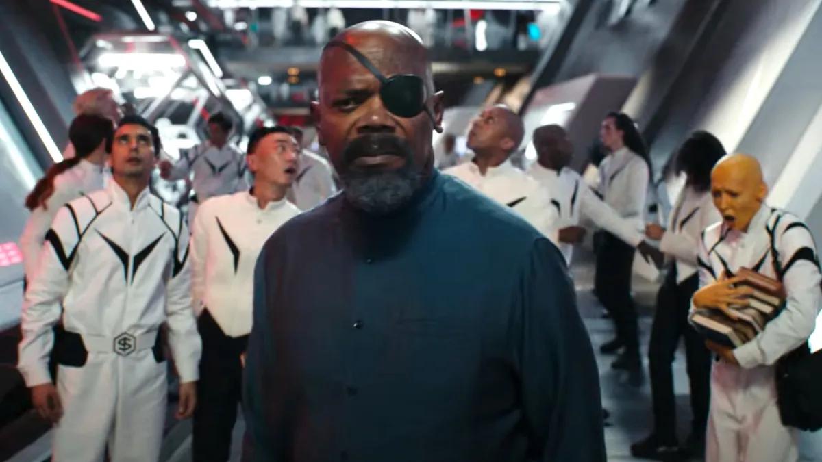 Nick Fury stares out into space with the SABER crew behind him in The Marvels