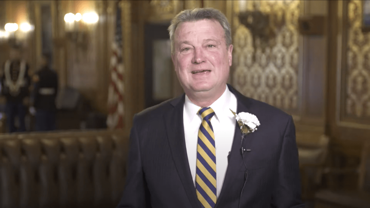 Rep. Joel Kitchens standing in front of an American flag.