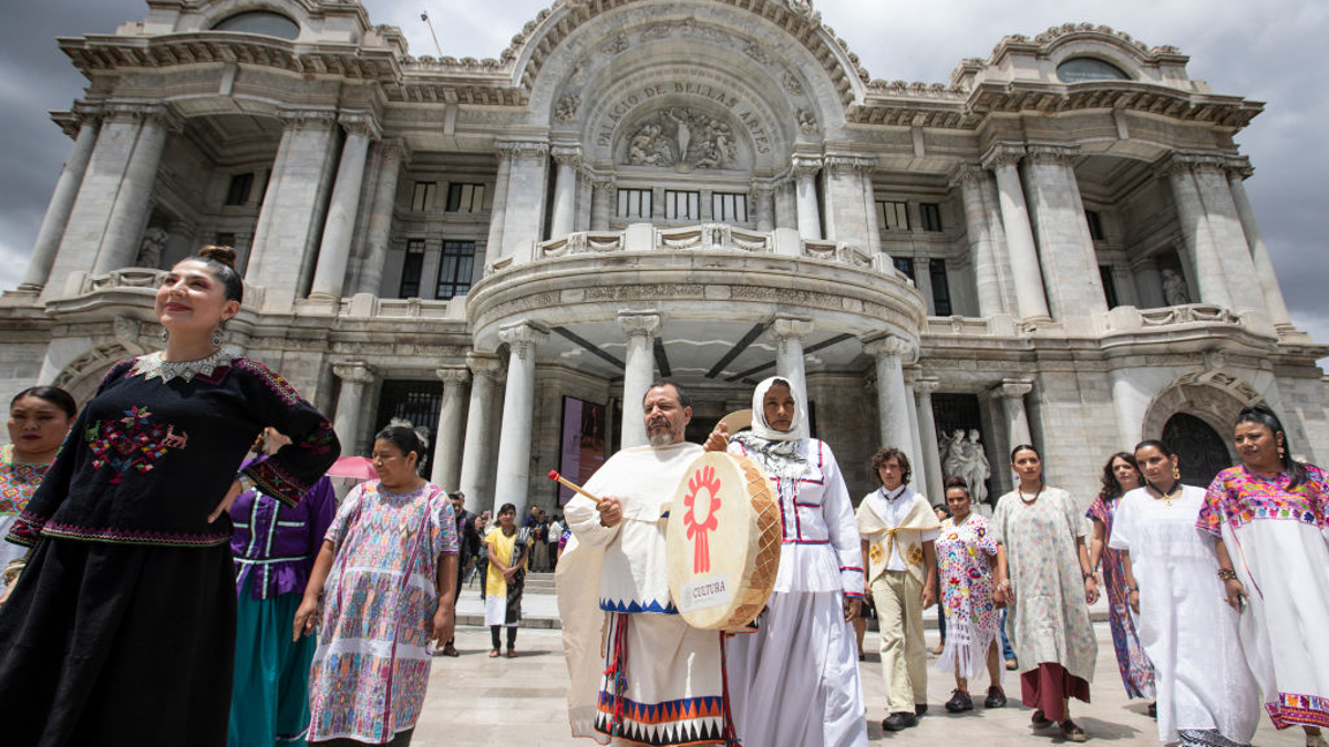 Models walk in front of 'Palacio de Bellas Artes' museum wearing the outfits made by the master craftsmen during a press conference on the event 'Original' at Palacio de Bellas Artes on August 24, 2023 in Mexico City, Mexico. 'Original' is a project conceived for many artisans to protect the creations, symbols and culture of many artisan communities in Mexico from plagiarism. 