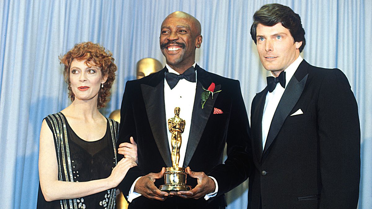 Hollywood, California: Actress Susan Sarandon (left) and Actor Christopher Reeves flank either side of Louis Gossett Jr., winner of the 1982 Academy Award for Best Supporting Actor for his role in An Officer and a Gentleman backstage during the Academy Awards Ceremony.