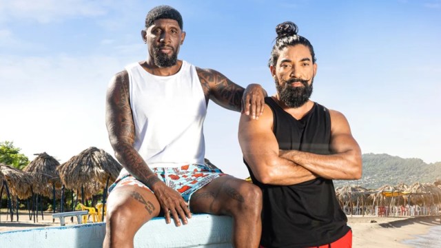 Carlos and Valentine pose together on the beach.