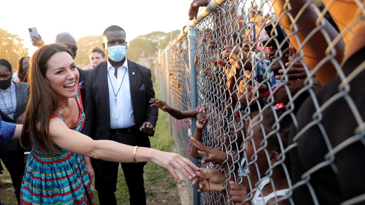 Catherine, Duchess of Cambridge shakes hands with children during a visit to Trench Town, the birthplace of reggae music, on day four of the Platinum Jubilee Royal Tour of the Caribbean on March 22, 2022 in Kingston, Jamaica. The Duke and Duchess of Cambridge are visiting Belize, Jamaica, and The Bahamas on their week-long tour. (Photo by Chris Jackson-Pool/Getty Images)