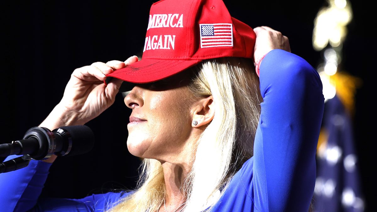 : Rep. Marjorie Taylor Greene (R-GA) puts on her Make America Great Again hat while addressing a campaign rally with Republican presidential candidate and former U.S. President Donald Trump at the Forum River Center March 09, 2024 in Rome, Georgia. Both Trump and President Joe Biden are holding campaign events on Saturday in Georgia, a critical battleground state two days before its primary elections. A city of about 38,000, Rome is in the heart of conservative northwest Georgia and the center of Greene's district. (Photo by Chip Somodevilla/Getty Images)