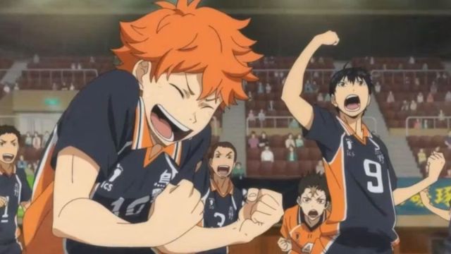 Haikyuu screengrab shows Hinata clenching his fists in excitement and Kageyama at the back jumping with excitement.