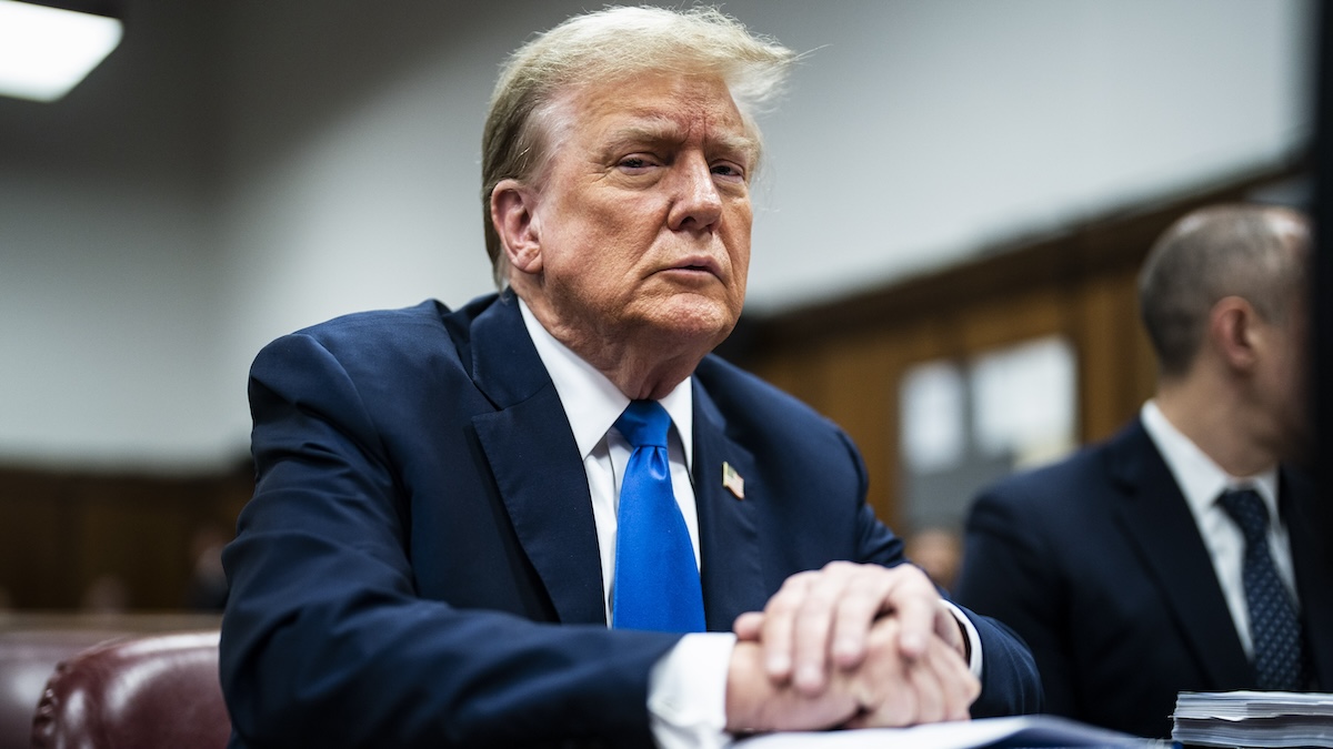 Donald Trump looking angry in a blue suit and blue tie in a New York courtroom