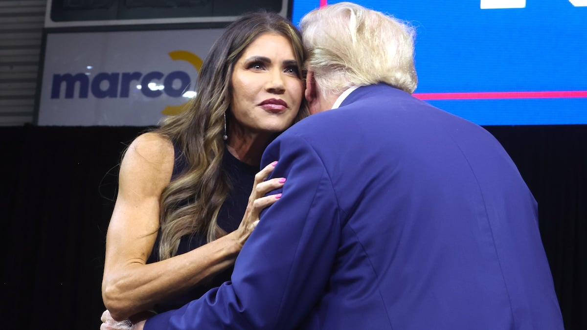 Kristi Noem hugs Donald Trump at the Monument Leaders Rally in Rapid City, South Dakota, 2023.