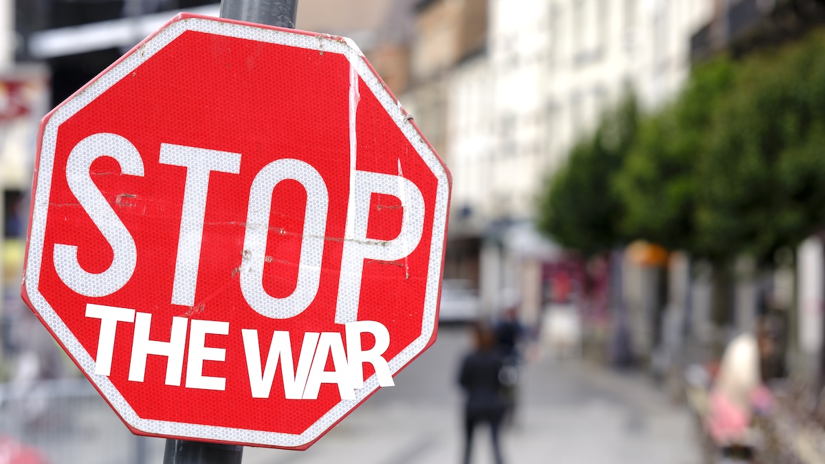 A red stop sign converted to read 'STOP THE WAR' in Brussels, Belgium, 2024.