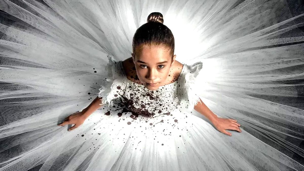 Alisha Weir wearing a blood-stained white ballerina dress in horror movie Abigail