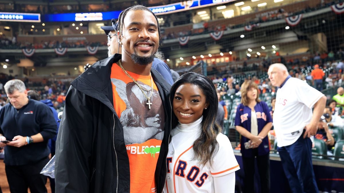 Simone Biles and Jonathan Owens pose on the field prior to Game One of the 2022 World Series between the Philadelphia Phillies and the Houston Astros at Minute Maid Park on October 28, 2022 in Houston, Texas. (Photo by Carmen Mandato/Getty Images) 