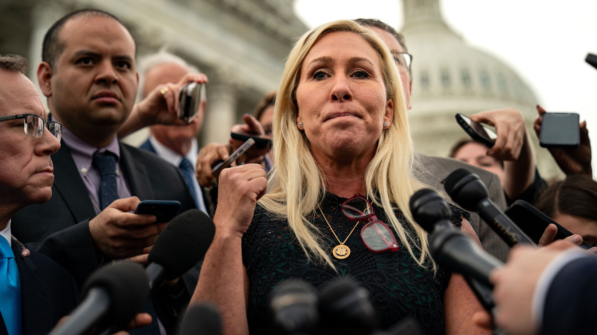 Rep. Marjorie Taylor Greene (R-GA), and Rep. Thomas Massie (R-KY) (behind), speak to members of the press on the steps of the House of Representatives at the U.S. Capitol on May 8, 2024 in Washington, DC. The House voted overwhelmingly to save Speaker Johnson from Marjorie Taylor Greene's push to oust him from his leadership position, voting 359 to 43 to table the motion to vacate.