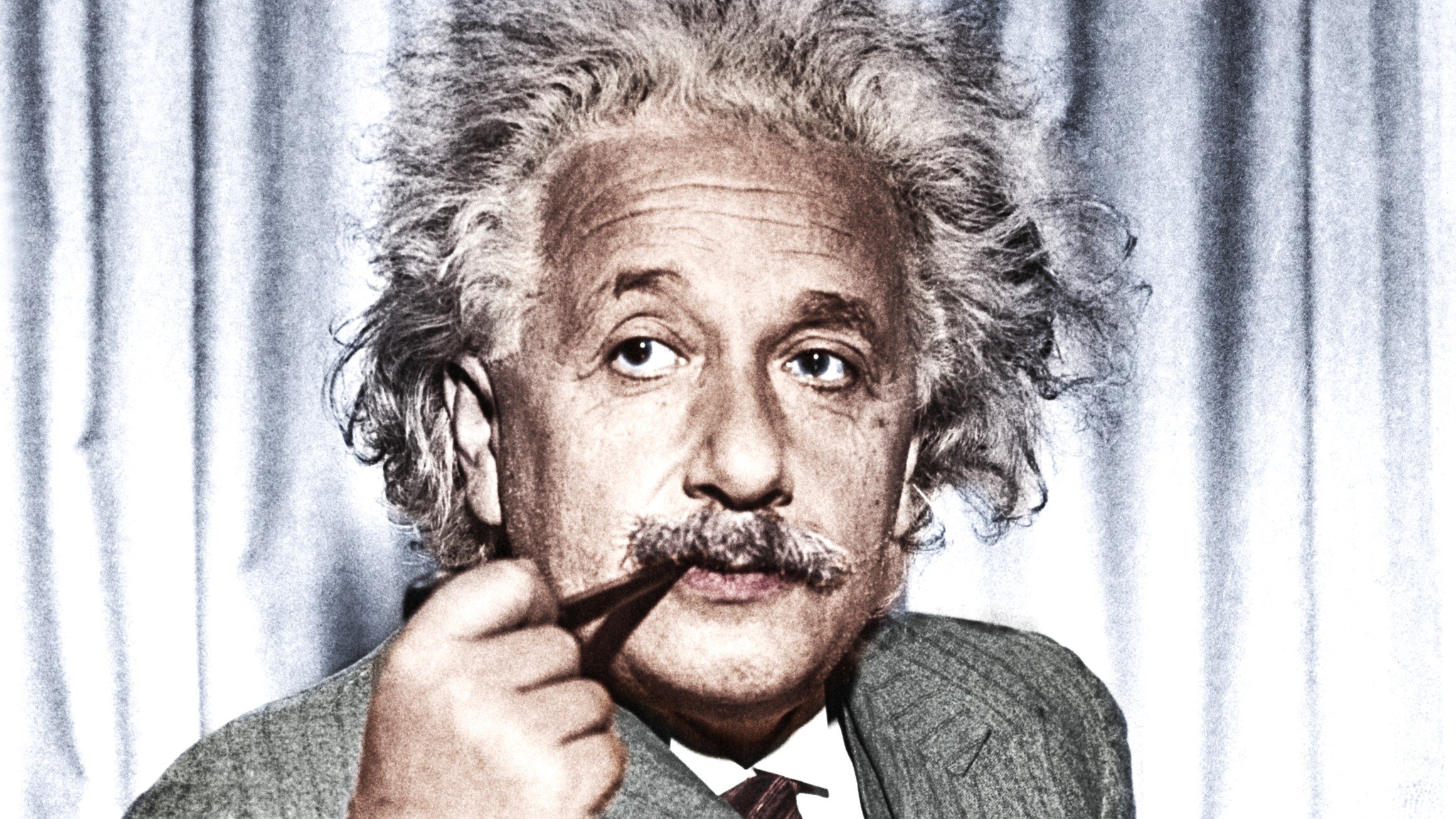 Professor Albert Einstein, now exiled from Germany, calmly smokes his pipe. He is in the United States to give a series of lectures to advanced students at Princeton University.