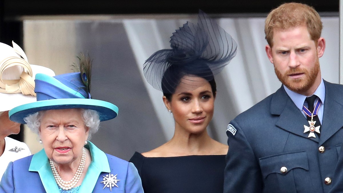 Queen Elizabeth II, Prince Harry, Duke of Sussex and Meghan, Duchess of Sussex on the balcony of Buckingham Palace as the Royal family attend events to mark the Centenary of the RAF on July 10, 2018 in London, England.