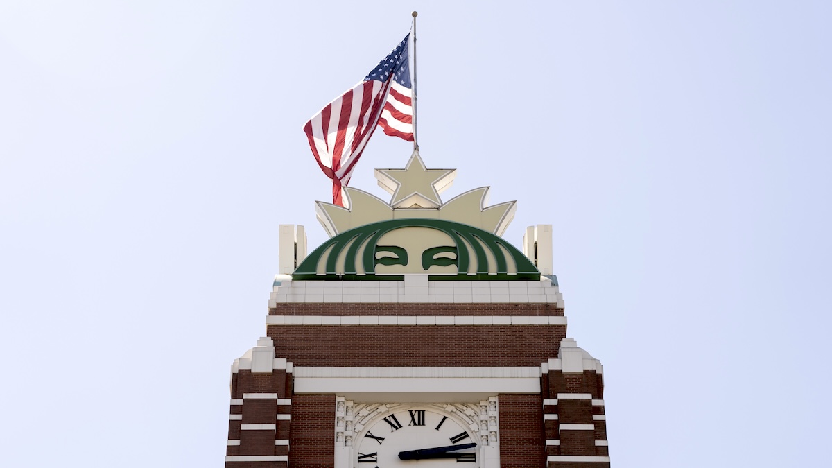 The American flag flying atop a logo at the Starbucks headquarters at Starbucks Center