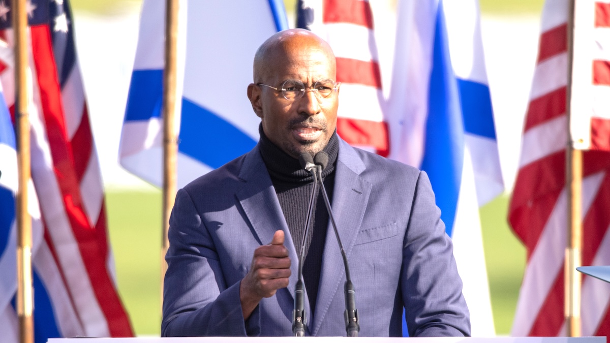 Van Jones speaking in front of flags at March For Israel