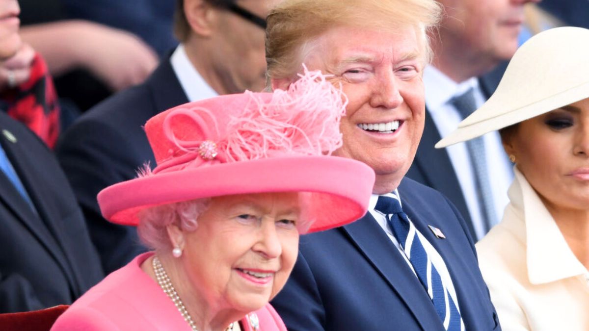 US President Donald Trump (R) reacts as he sits with Britain's Queen Elizabeth II during an event