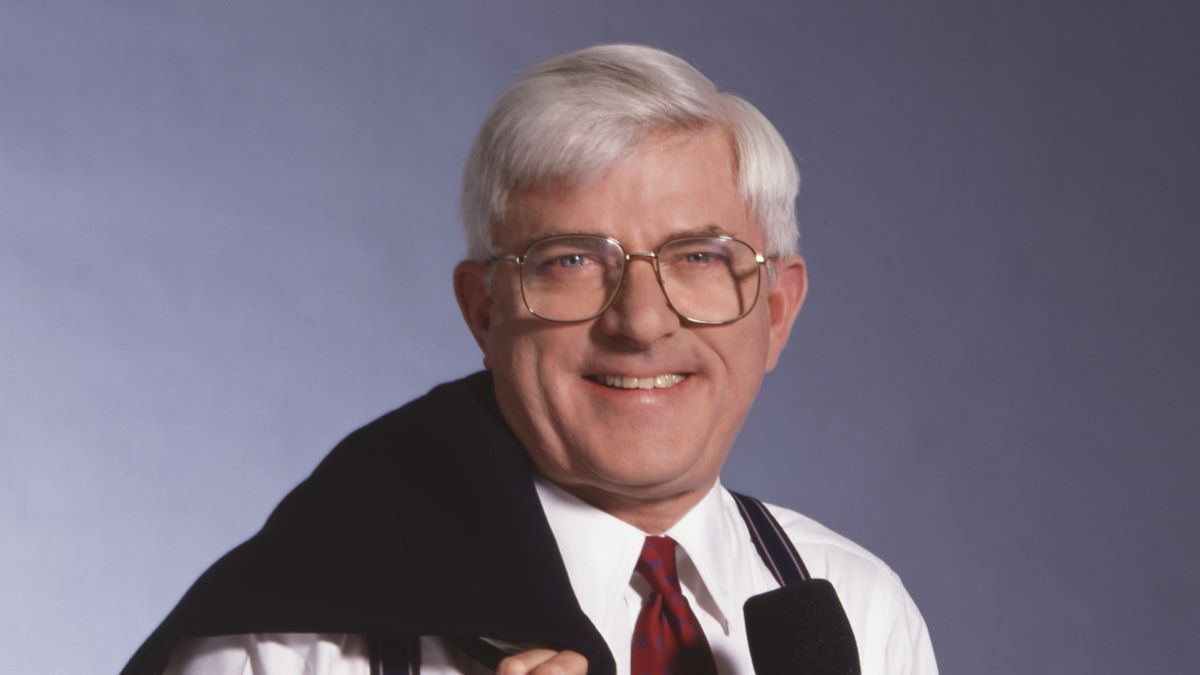 Portrait of American television personality Phil Donahue as he poses with his jacket over his shoulder and a microphone in one hand, New York, New York, May 19, 1992. This photo was taken as part of a shoot for TV Guide magazine. (Photo by Michel Delsol/Getty Images)