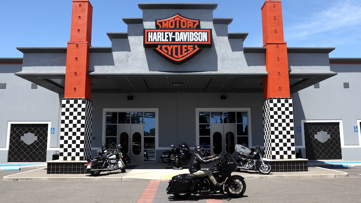 A motorcyclist rides his Harley-Davidson motorcycle in front of Oakland Harley-Davidson