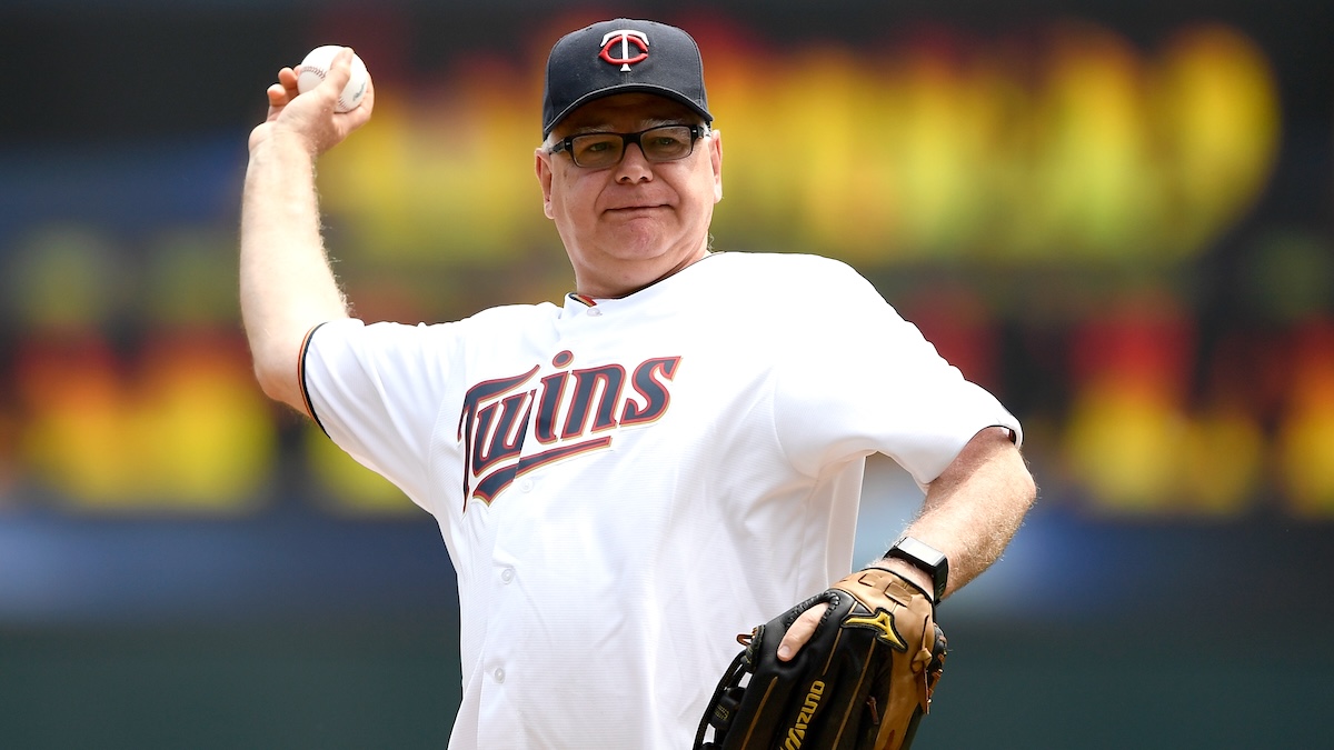 Governor of Minnesota Tim Walz delivers the ceremonial first pitch before the game between the Minnesota Twins and the Texas Rangers