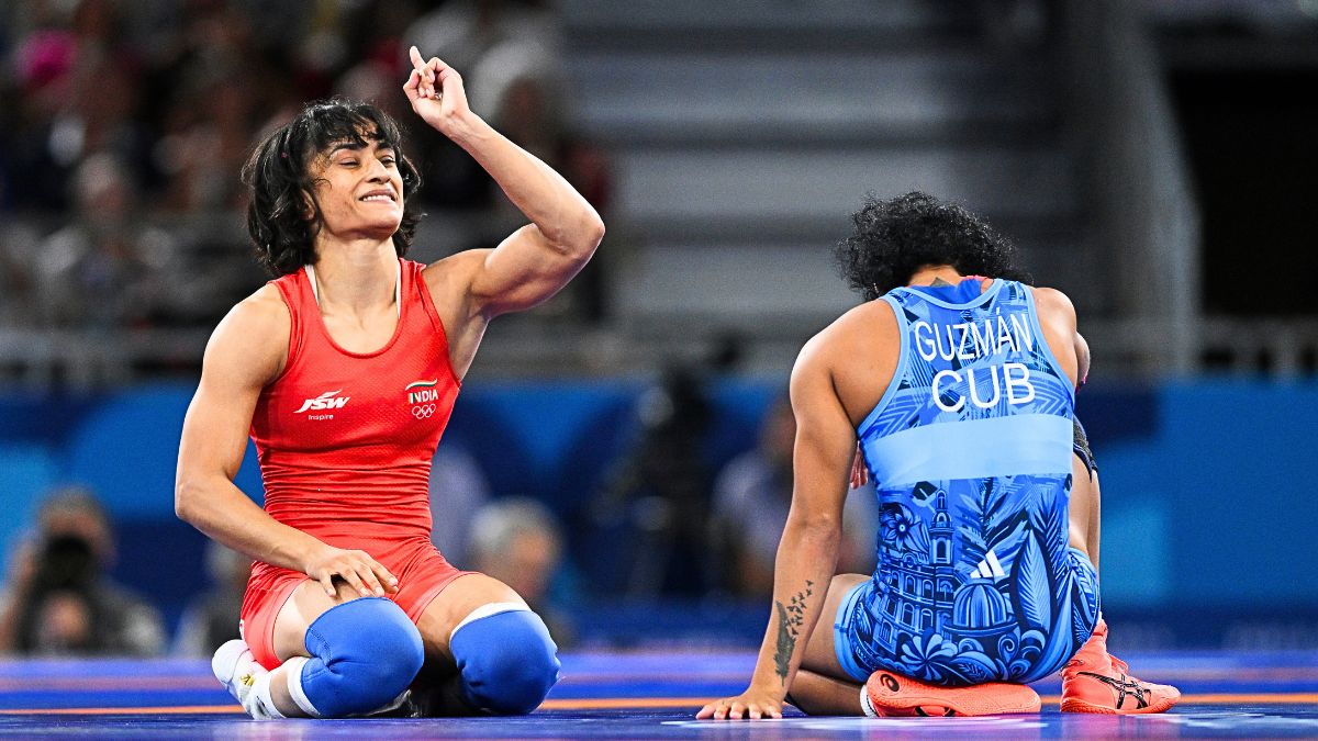 Vinesh Vinesh of Team India (red) celebrates victory against Yusneylis Guzman Lopez of Team Cuba (blue) during the Wrestling Women's Freestyle 50kg Semifinal on day eleven of the Olympic Games Paris 2024 at Champs-de-Mars Arena on August 06, 2024 in Paris, France.