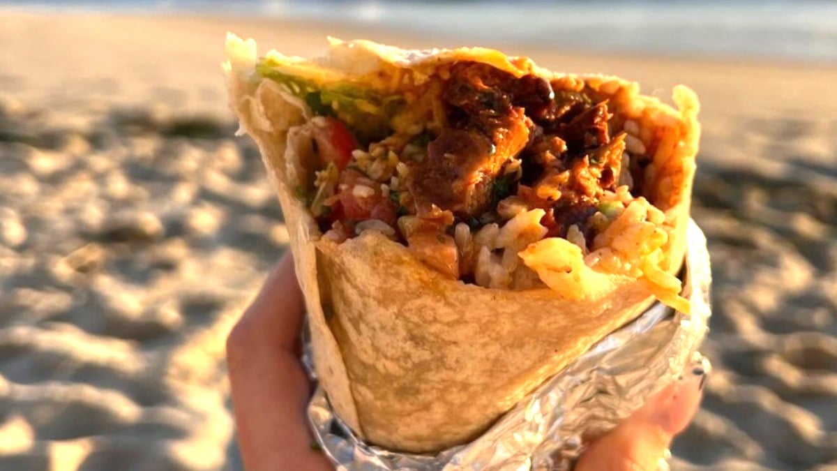 A Chipotle burrito in the sand